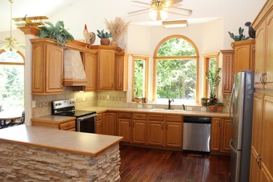 Stainless appliances with many cabinets.