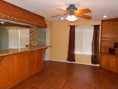 Kitchen featuring dark wood-style floors, light st