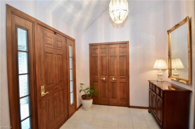 Foyer entry with vaulted ceiling and ceramic tile 