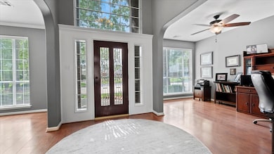 Bright entryway featuring a large wooden front doo