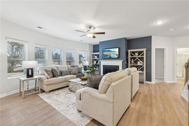 Living room with baseboards, light wood finished f