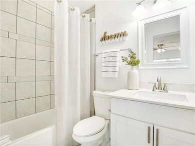 Full bathroom with toilet, shower / bath combo wi
