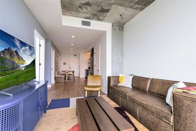Living area with visible vents, baseboards, and w