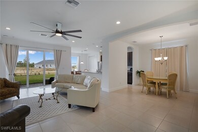 Living room featuring ceiling fan with notable cha