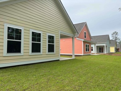 Back of house with a yard