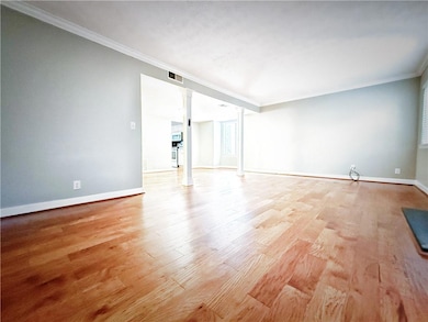 Spare room with ornamental molding, ornate columns