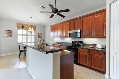 Large kitchen with loads of cabinets.  Granite cou