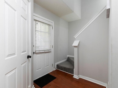 Doorway to outside with stairs and wood finished floors