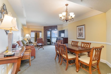 Carpeted dining room with crown molding, a notable