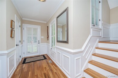 Foyer with picture moulding and hardwoods