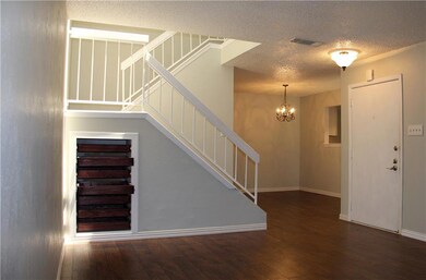 Stairs with a textured ceiling, a chandelier, har