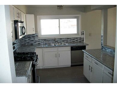 Property Photo. Kitchen with modern tile, and gran