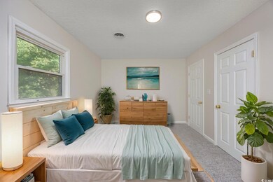 Bedroom featuring a textured ceiling and carpet fl