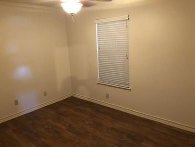 Empty room featuring dark wood-style floors, a ce