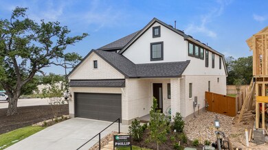 View of front of home featuring roof with shingle