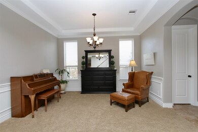 The Formal Dining Room also features wainscoting and windows with side yard views.