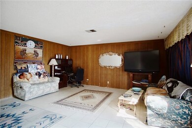 Living room is spacious with tile flooring