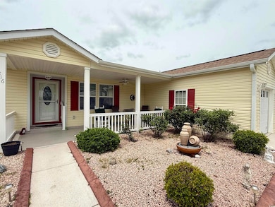 View of front of house featuring a porch, a garage, and roof with shingles