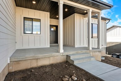 Doorway to property featuring board and batten siding and covered porch