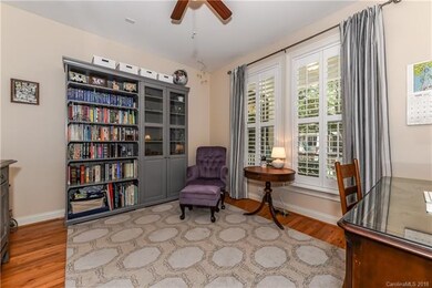 Office has large windows, plantation shutters and 