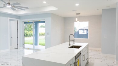 Kitchen featuring a sink, baseboards, recessed lig