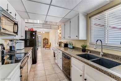Kitchen featuring black appliances, a paneled ceil