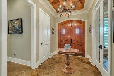 Entrance has beautiful arched double doorway and w