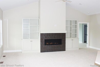 Living room with vaulted ceiling and fireplace