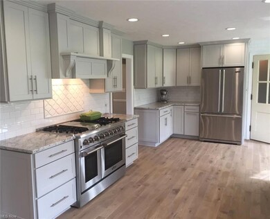 Spectacular bright white kitchen with hard wood fl