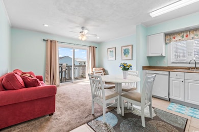 Dining space featuring a ceiling fan, a textured ceiling, recessed lighting, light tile patterned flooring, and light carpet
