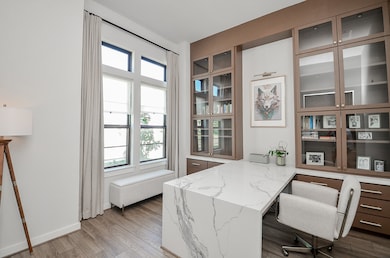 A beautifully designed home office or study featuring elegant cabinetry and ample natural light perfect for productivity and inspiration.