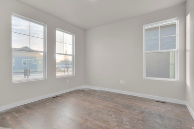 Empty room with baseboards and light wood-style flooring