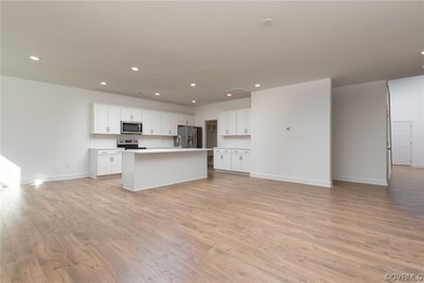 Kitchen featuring a center island with sink, light