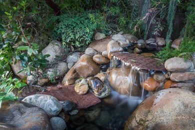Relax by the calm flowing water fall with a glass 