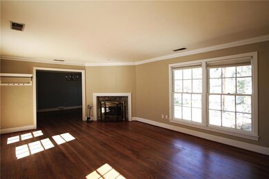 Unfurnished living room with crown molding, basebo