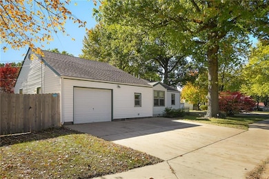 Wide driveway with an attached garage offering easy parking and access.
