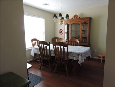 Ranch-style home with a front lawn, an attached ga