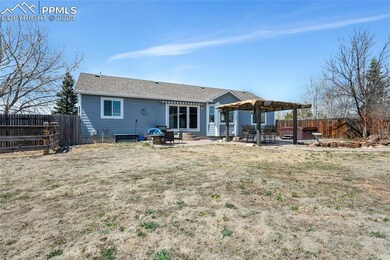 Rear view of property featuring a patio area, a ya