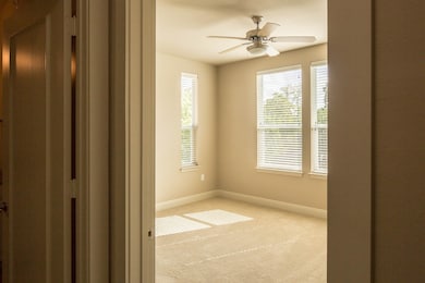Spare room with carpet floors and ceiling fan