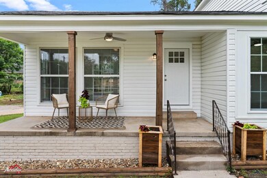 Doorway to property featuring covered porch
