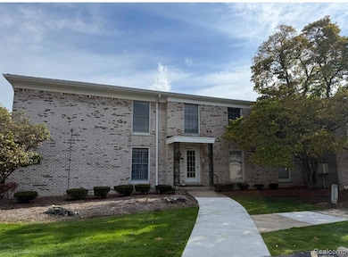 View of front facade featuring brick siding and a front lawn