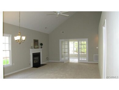 family room with vaulted ceilings looking into the