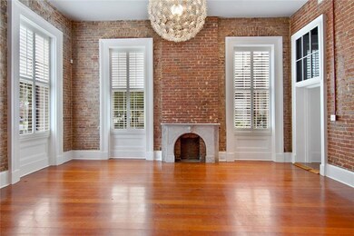 The living room with over 14' ceilings, wood floor