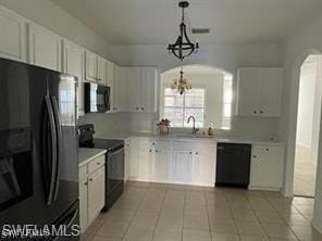 Kitchen featuring black appliances, a chandelier,