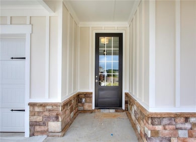 View of exterior entry with stone siding