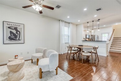 Living room with wood finished floors, stairs, ce