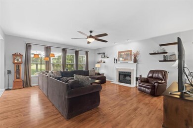 Spacious family room with 9' ceilings, a cozy fireplace and a wall of windows overlooking the back yard!