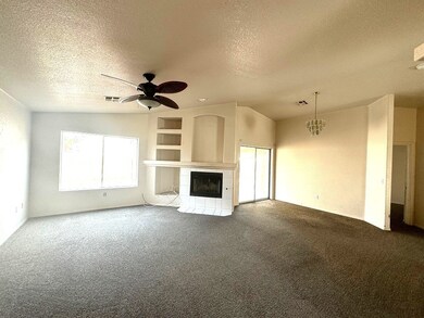 Living space with media shelving and fireplace