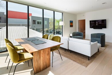 Living room with visible vents, a wall of windows