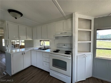 Kitchen featuring white range with electric cookto